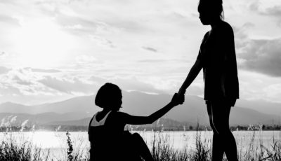 young girl help another girl to stand